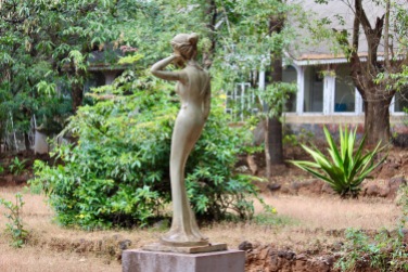 A sculpture in the garden of an abandoned bungalow